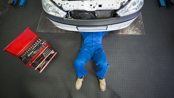 A mechanic repairing a car